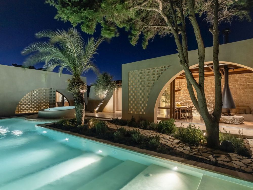 Crete House Villa by Entopos Architects pool by night