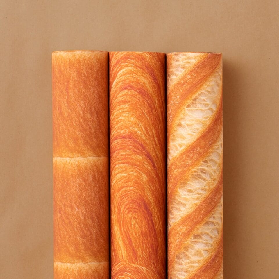 three rolls of wrapping paper lined up next to each other with realistic bread designs
