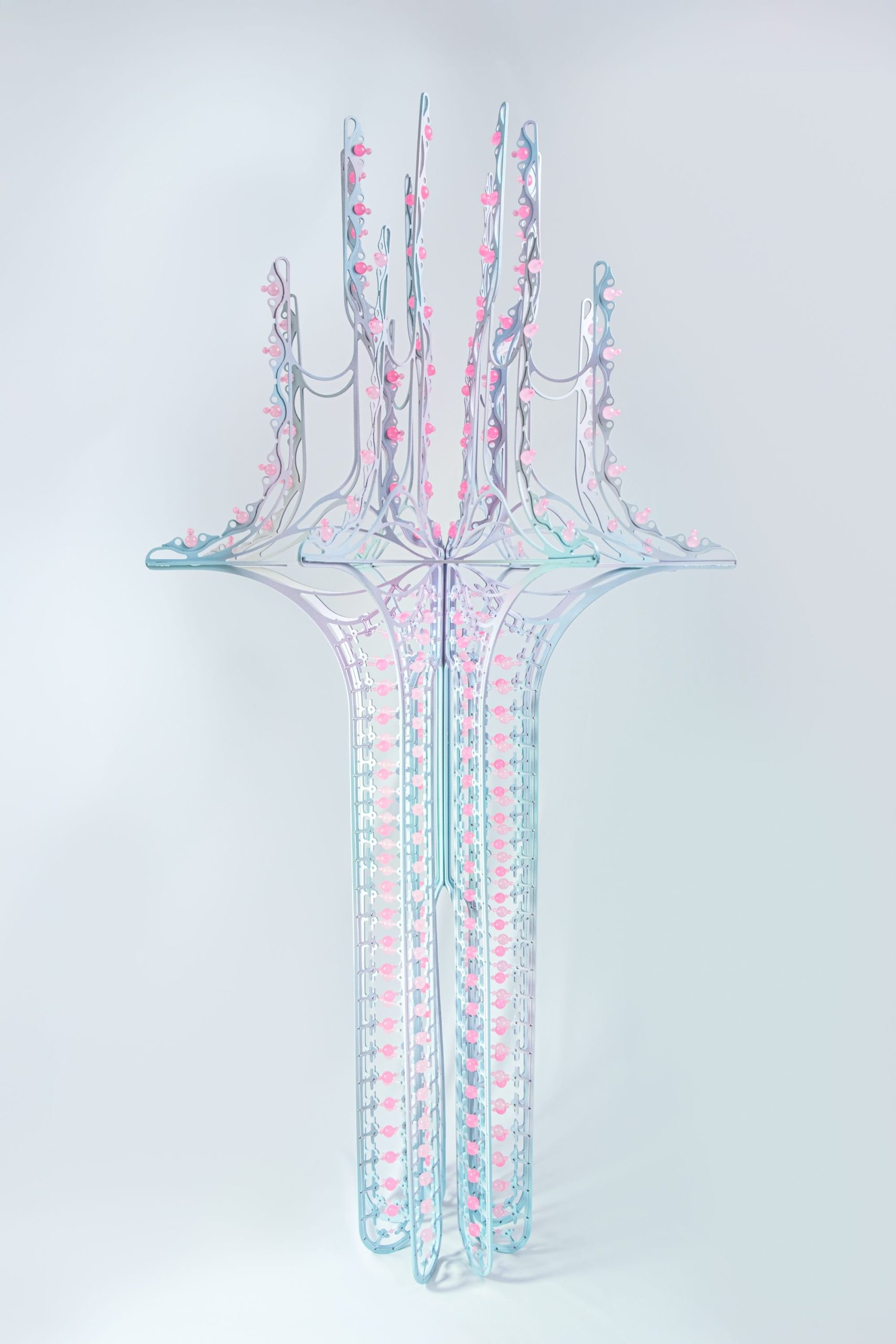 a tall pink and purple curved sculpture with scalloped edges