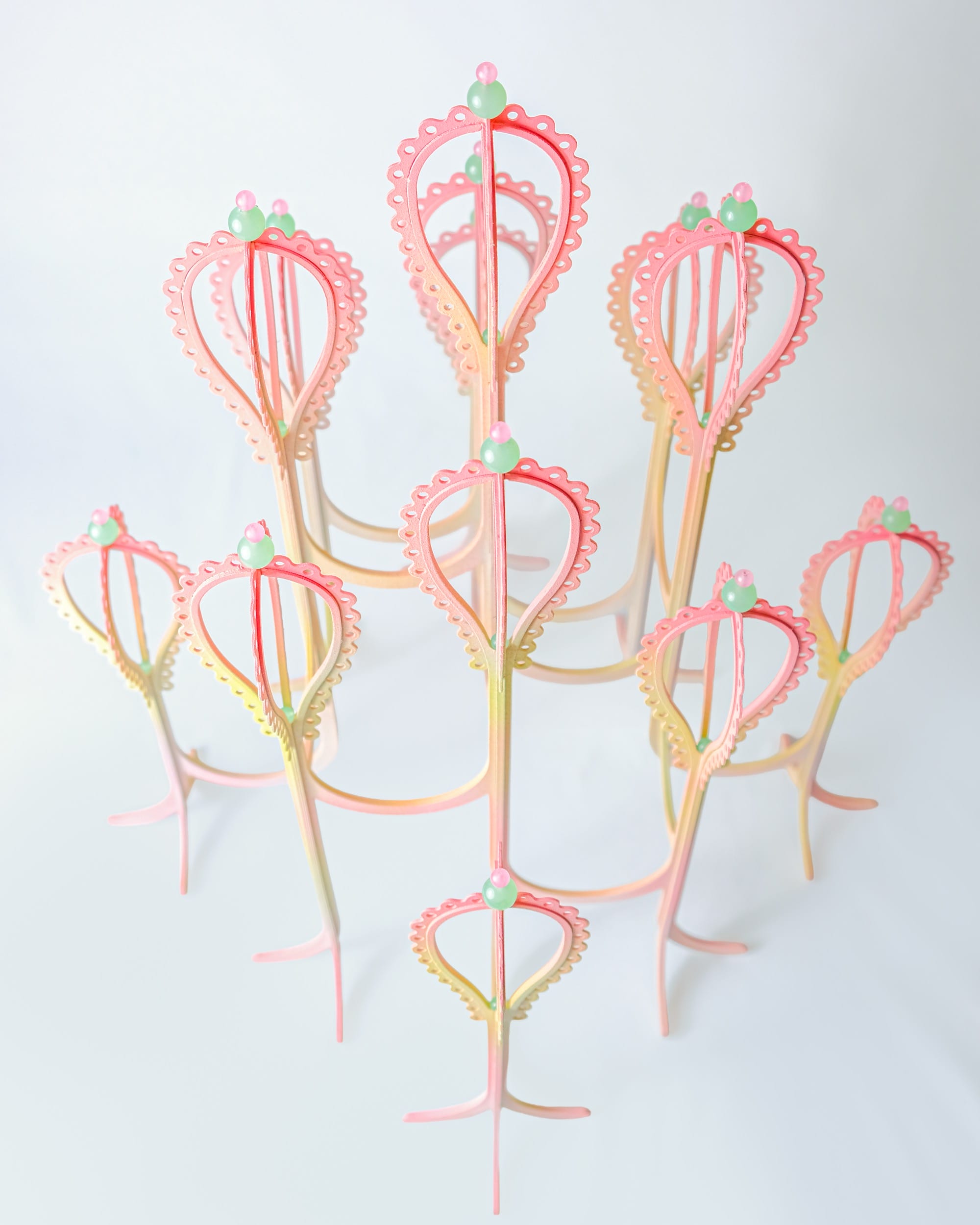 a pink and yellow curved sculpture with scalloped edges