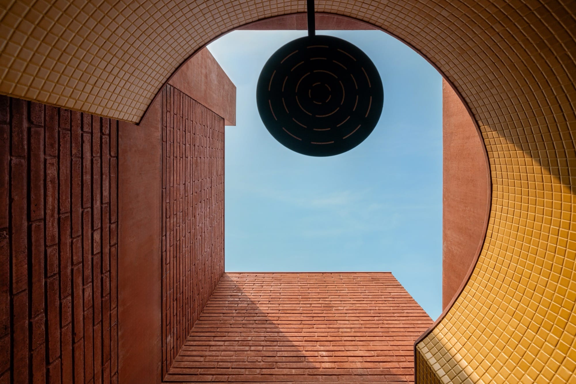 a detail of a contemporary brick home, looking upward at the sky