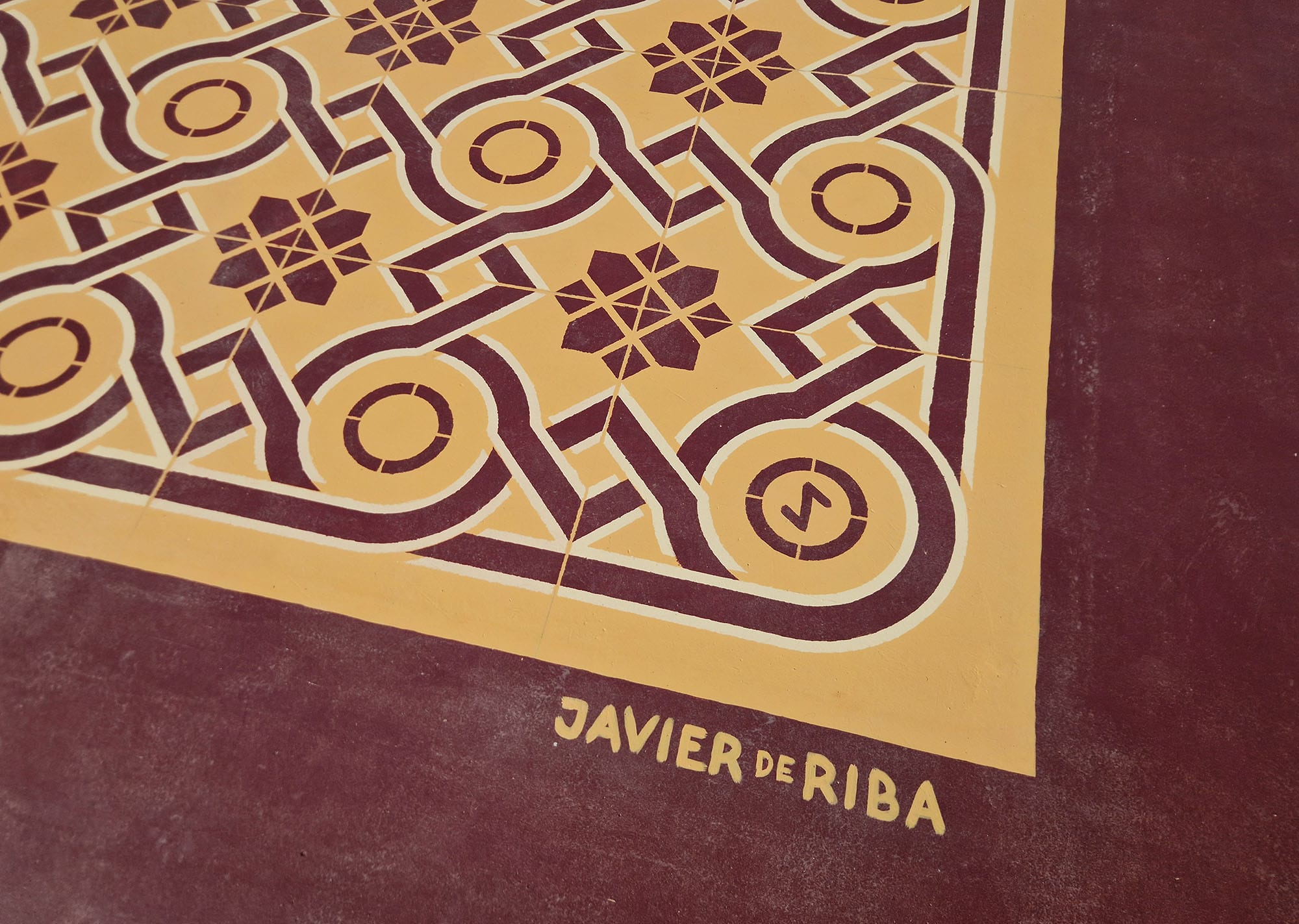 a detail of a red and yellow patterned rug