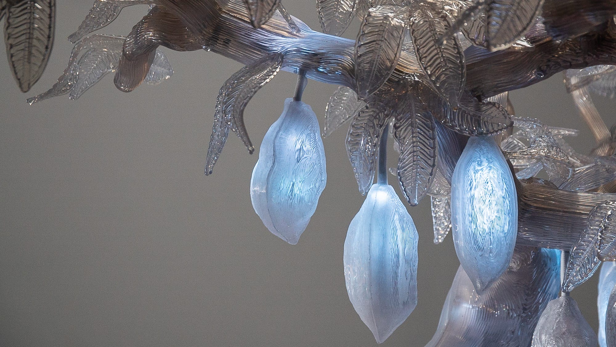 a detail of a sculpture of a clear, illuminated cacao tree