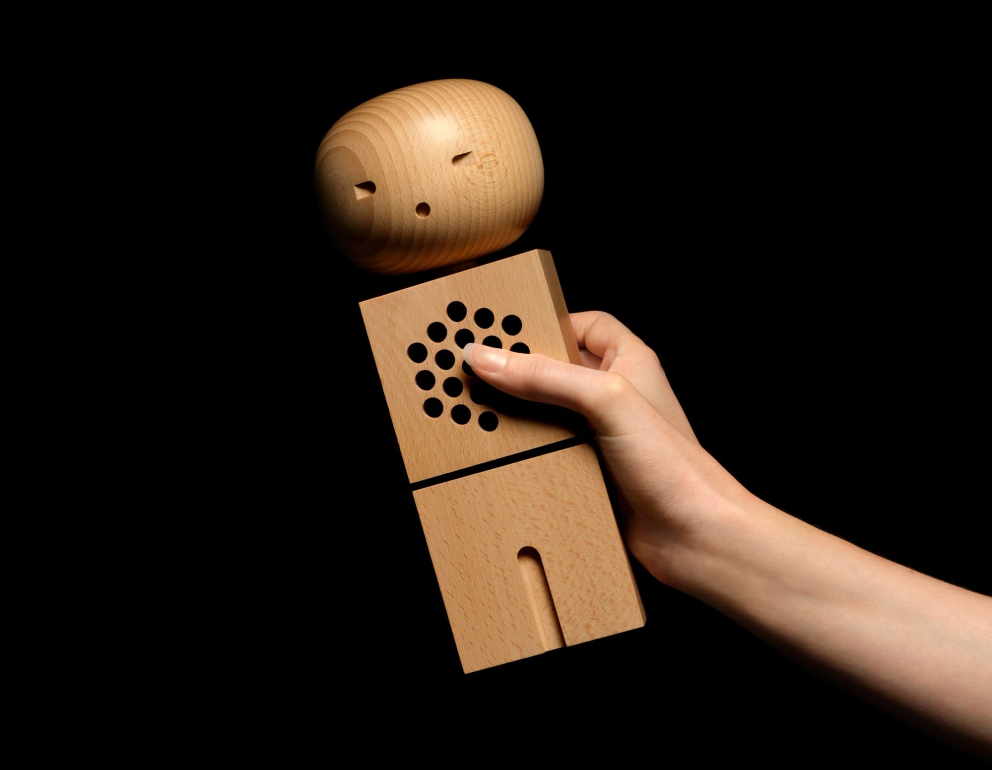 an abstract wooden figure with speakers inside