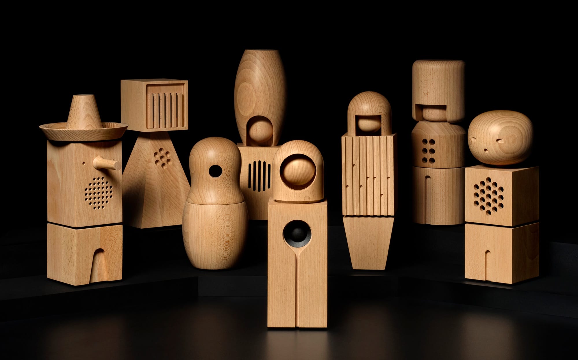 a set of abstract wooden figures with speakers inside