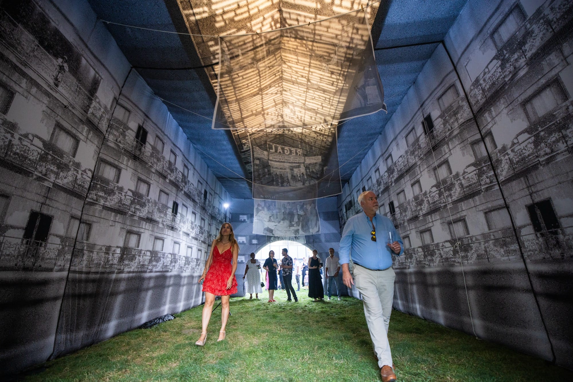 people walk through an inflatable building
