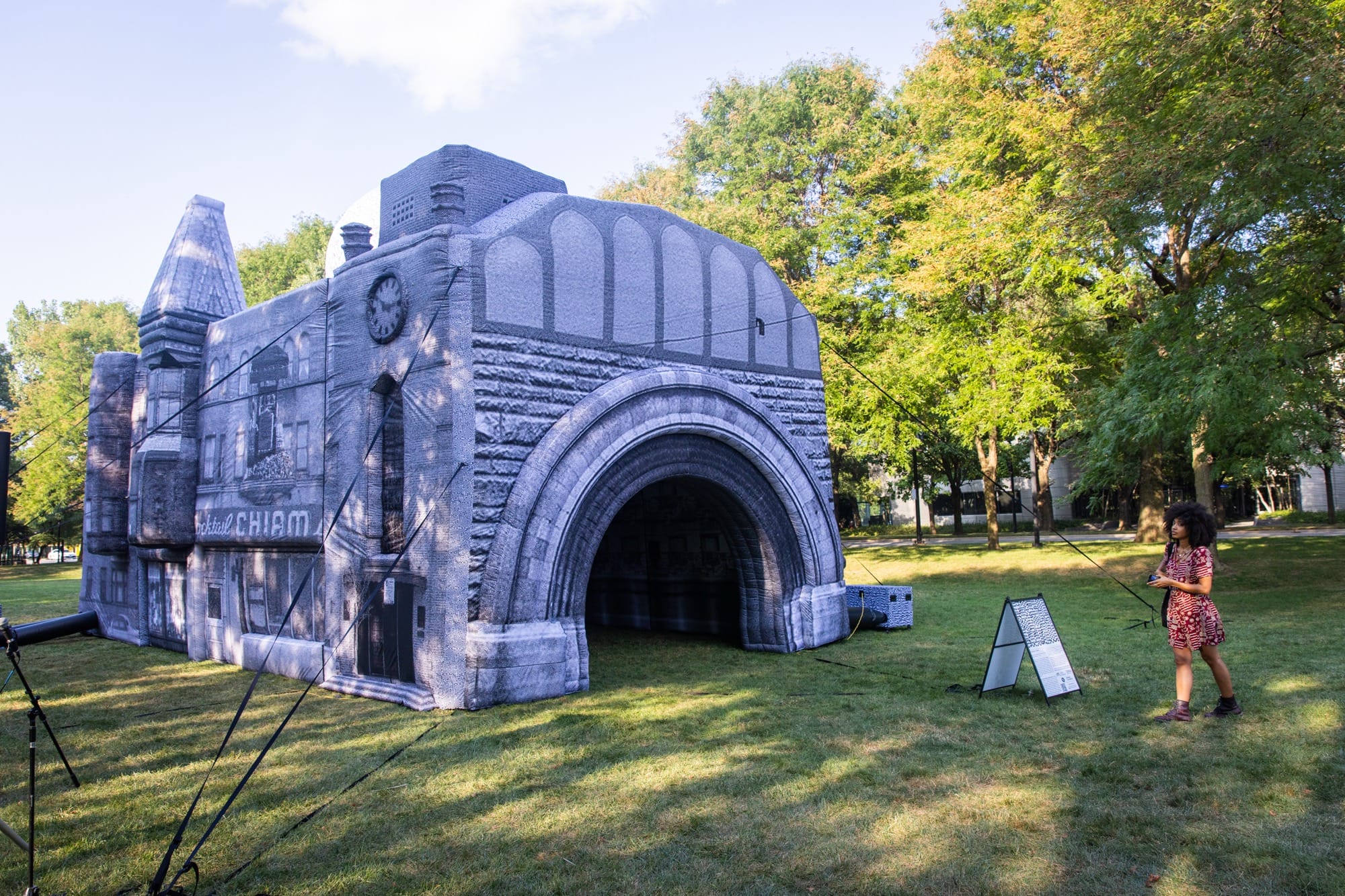 a person walks around a large, inflatable building