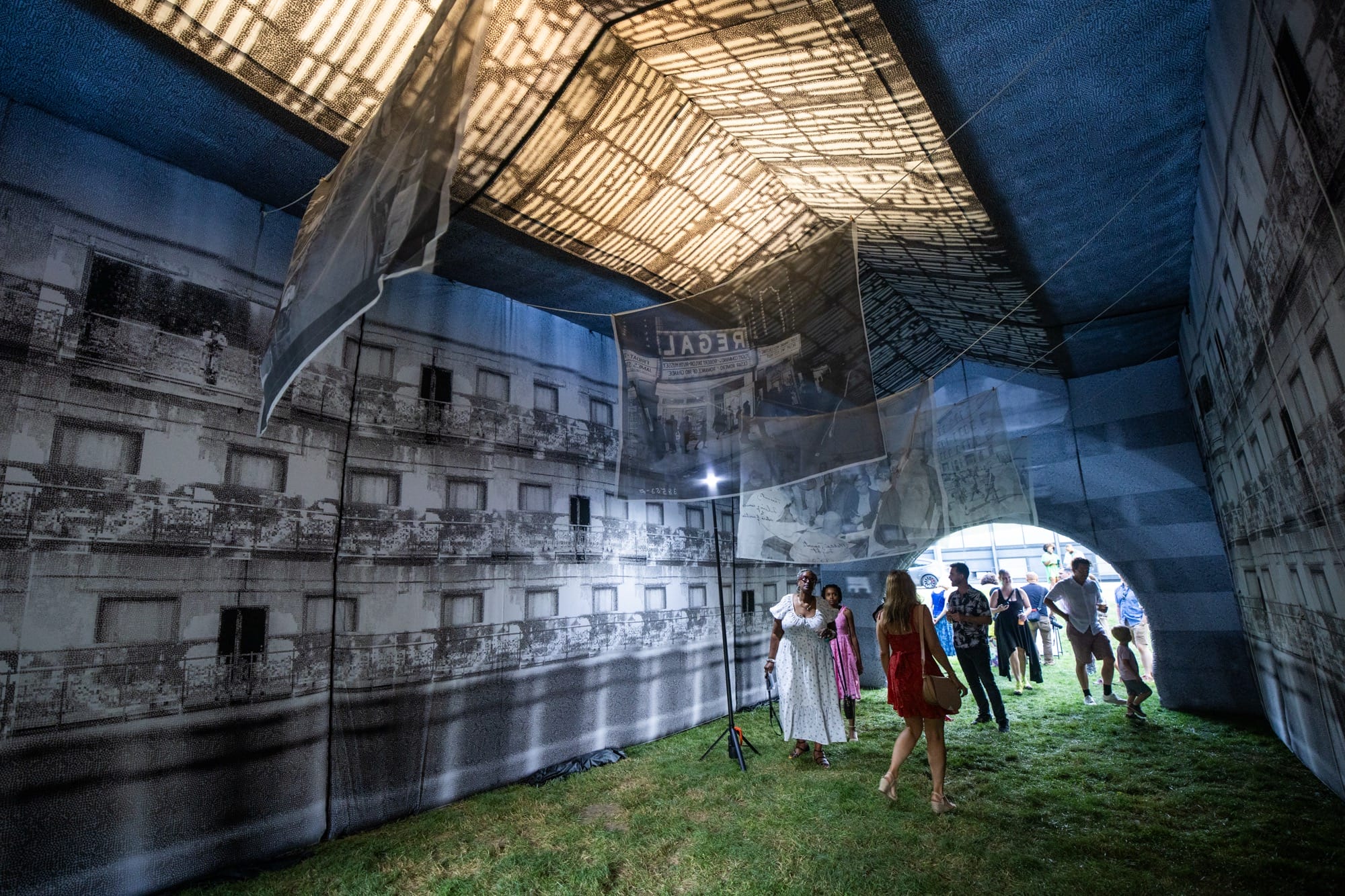 people walk through an inflatable building