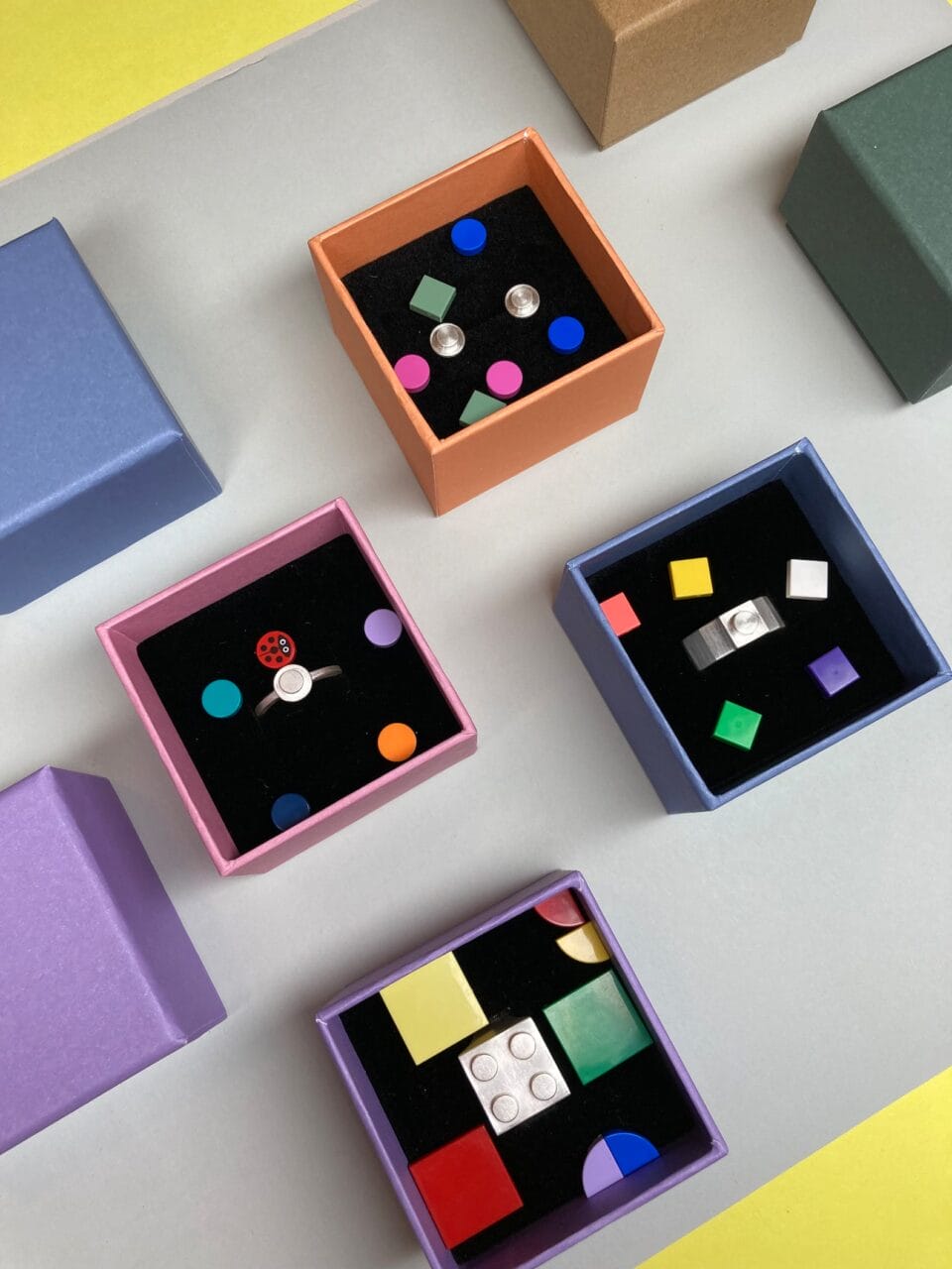 boxes of rings and earrings made by Studio GOGO on which LEGO bricks can be attached