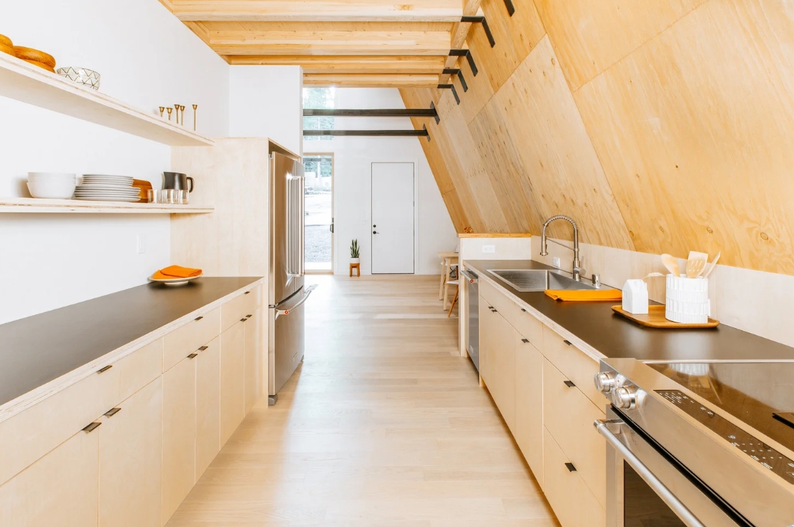 A frame House Stephenson Design Collective kitchen area plywood walls