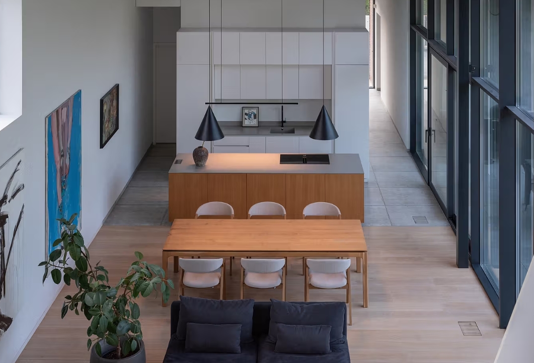 Residential House Kaunas Lithuania white cabinets kitchen and dining table wood natural