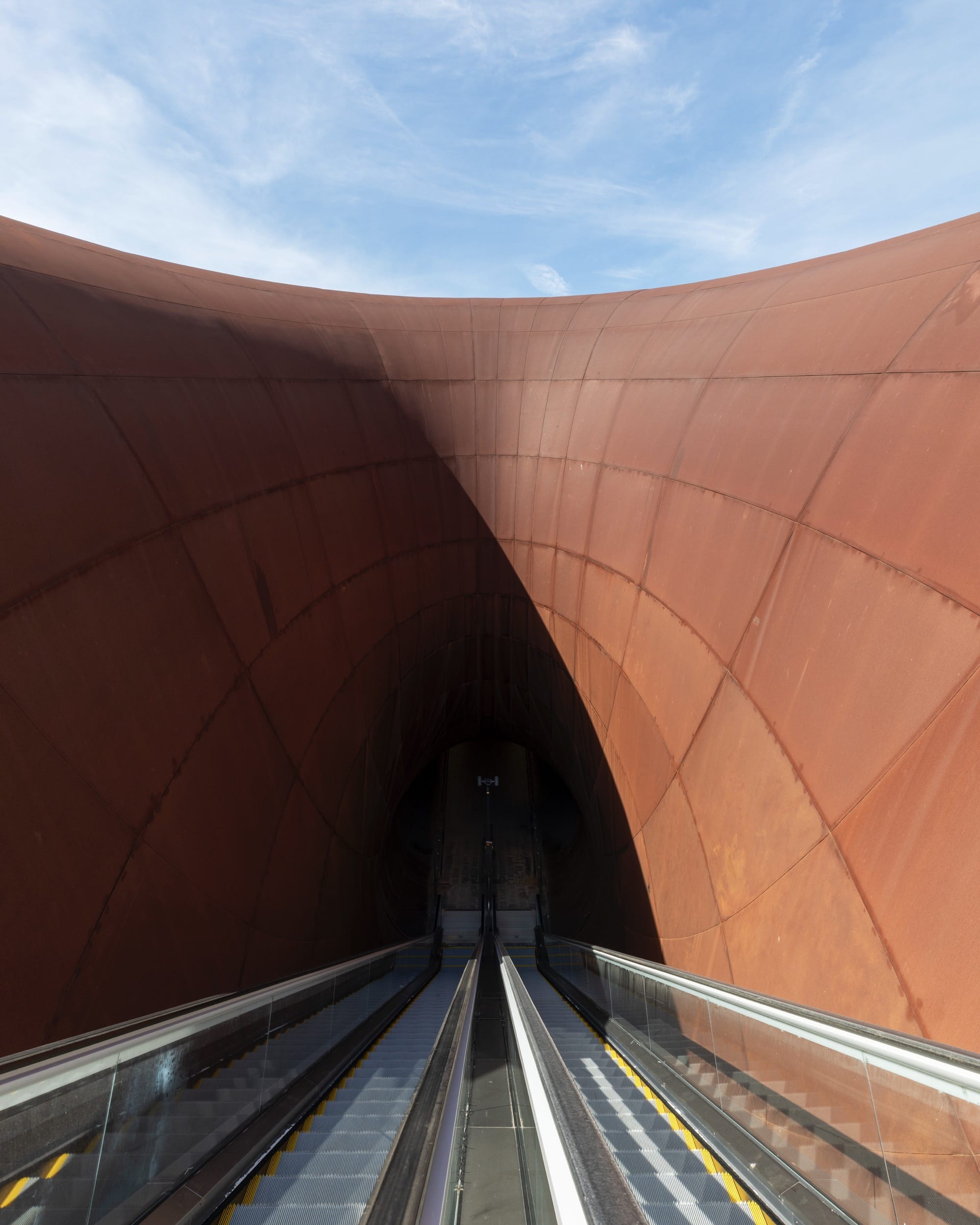 the entrance to a contemporary train station in Naples designed by Anish Kapoor