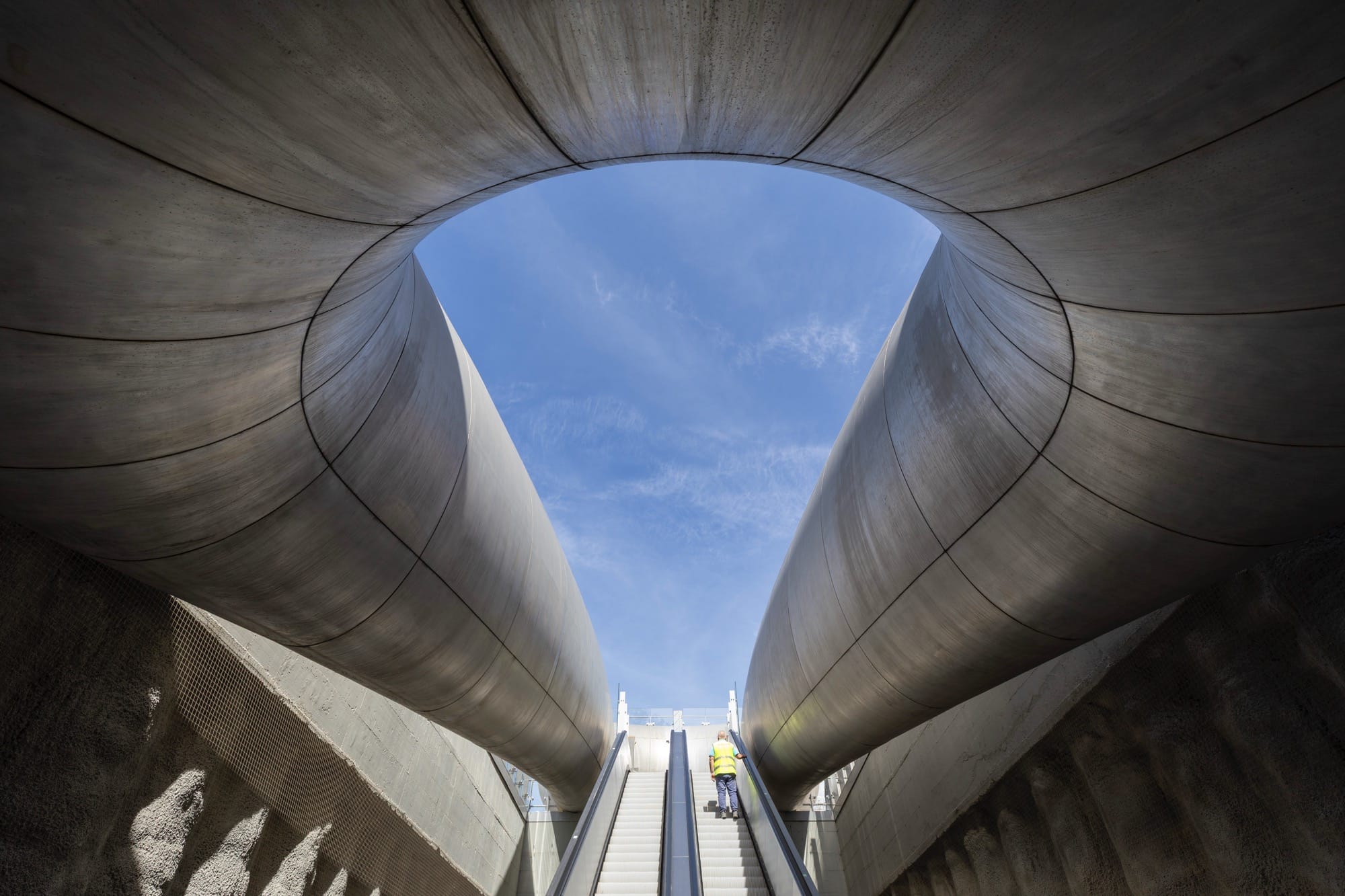 escalators leading up from a contemporary train station in Naples designed by Anish Kapoor