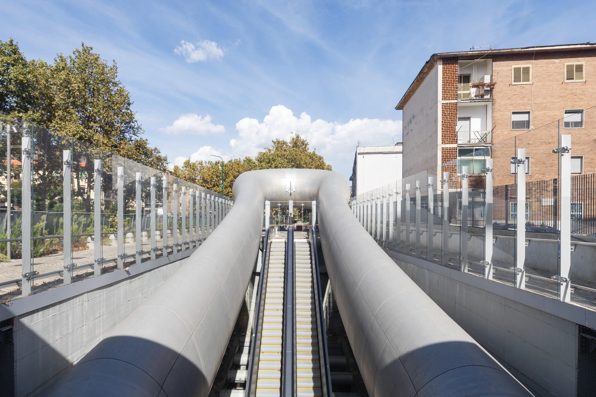 escalators leading up from a contemporary train station in Naples designed by Anish Kapoor