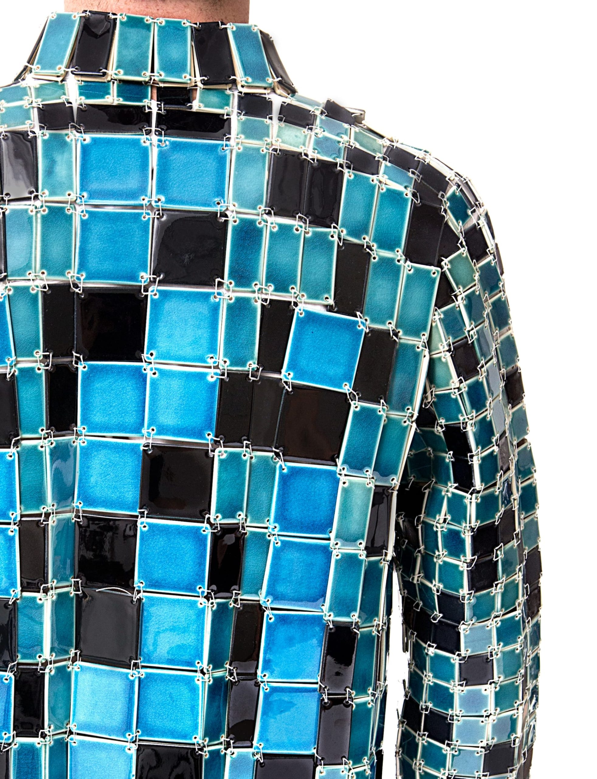 the back of Shae Bishop wearing a blue and black tile button up shirt