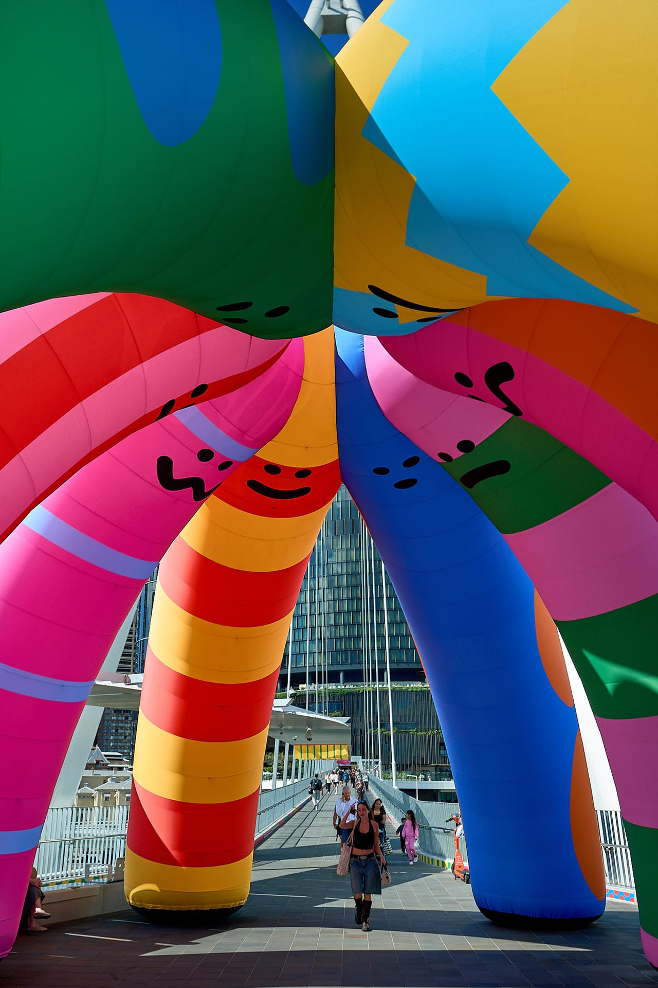 the underside of a colorful, inflatable installation by Craig & Karl of crayon-like shapes with expressive faces