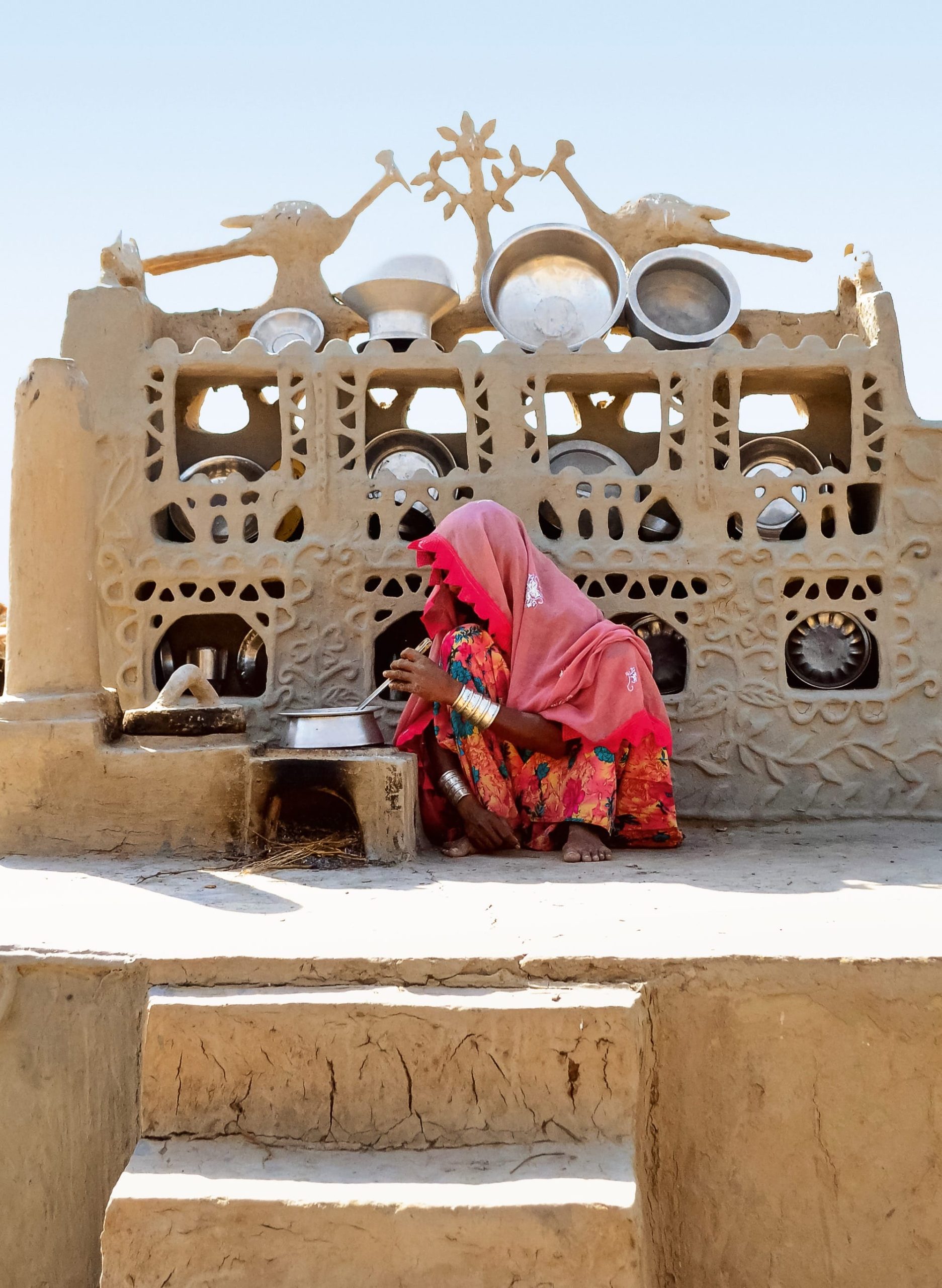 a photo of a woman crouching down to cook