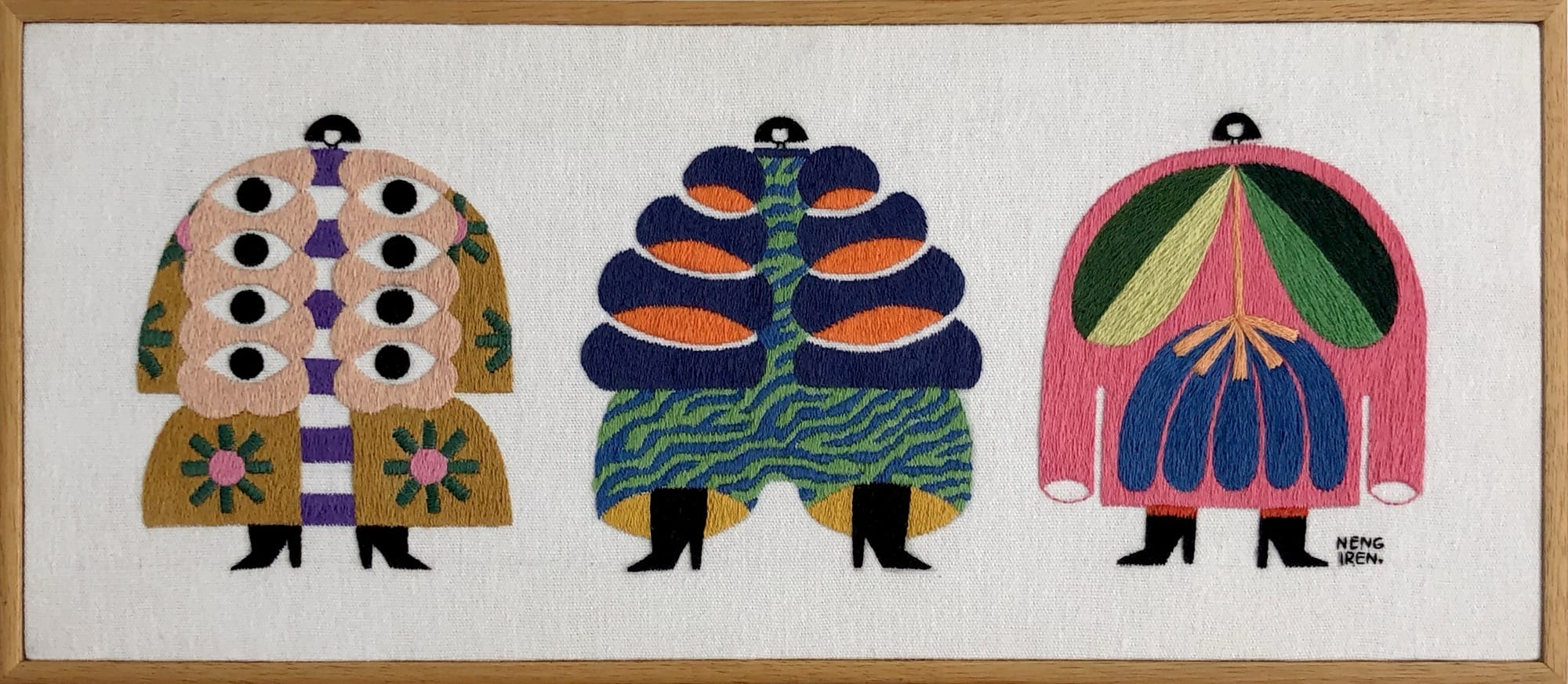 an embroidered artwork by Irene Saputra of three colorful, patterned, symmetrical, abstractly shaped figures