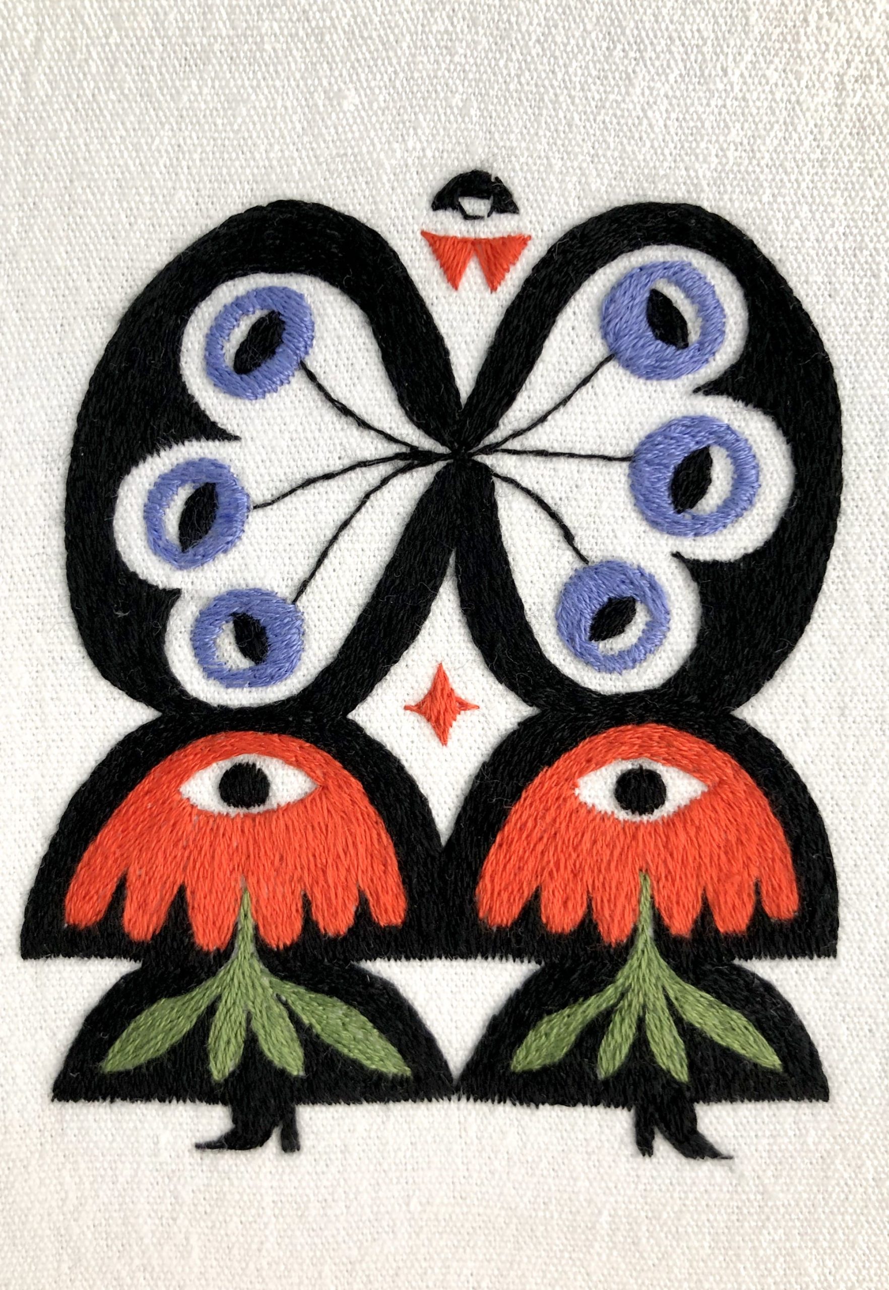 a detail of an embroidered artwork by Irene Saputra of a colorful, patterned, symmetrical, abstractly shaped figure