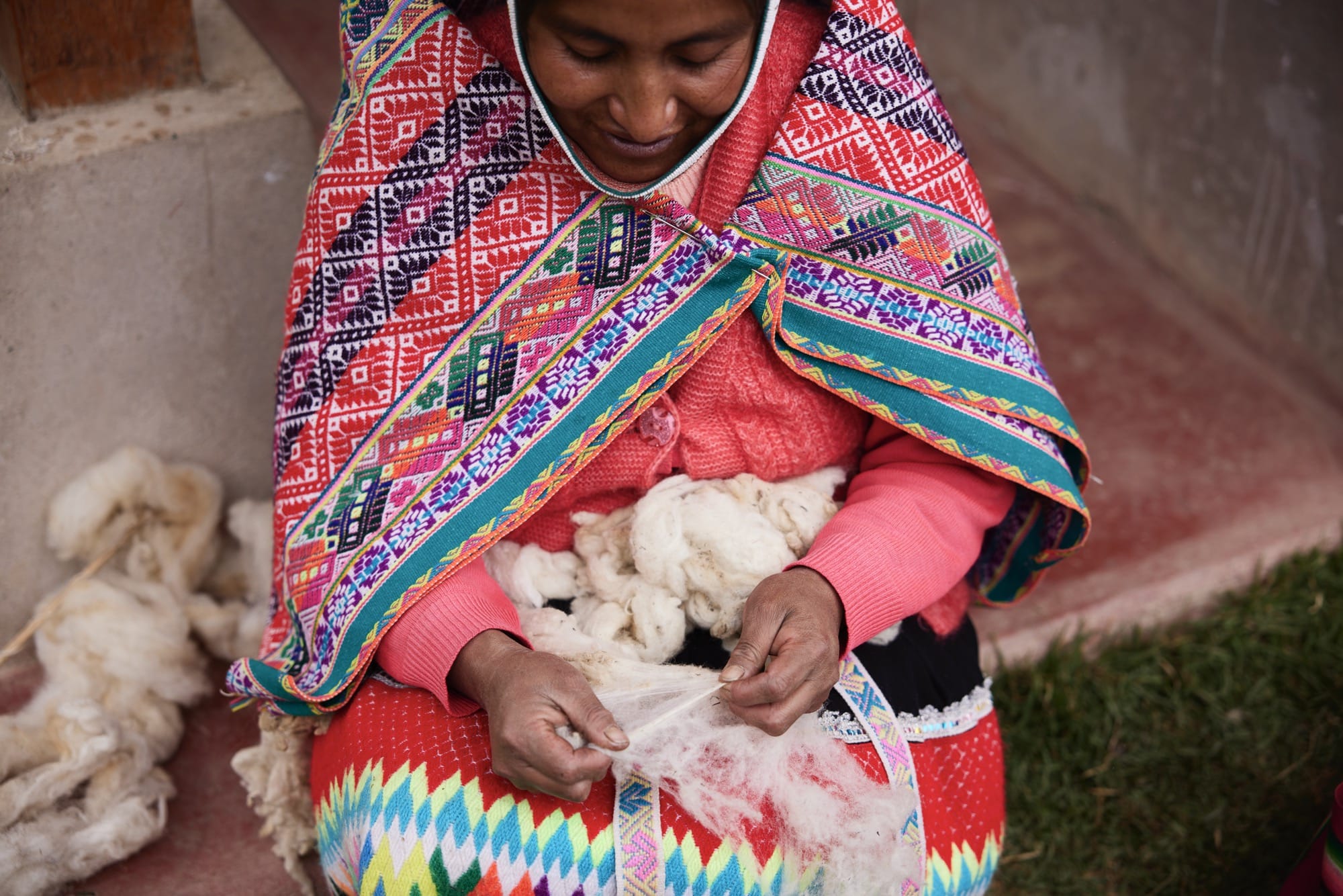 a woman carding wool